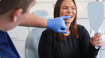 Dr Sean Roberts assessing a patient's smile during a teeth whitening consultation