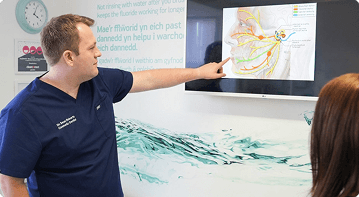Dr Sean Roberts explaining facial anatomy during a facial aesthetics consultation in Aberystwyth
