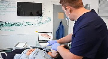 Dr Sean Roberts using an intraoral scanner for restorative dental treatment planning